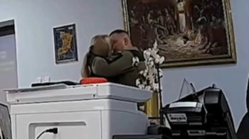 Військовий цілується з жінкою в робочому кабінеті, скриншот з відео